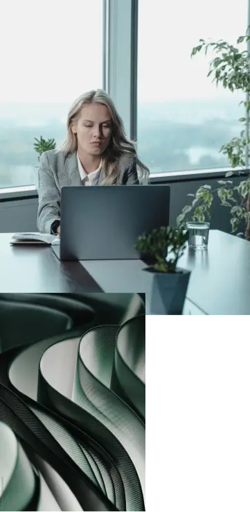 1. A person in a suit typing on a laptop in a high office with several plants around the space. 2. Abstract image of curving grey lines.
