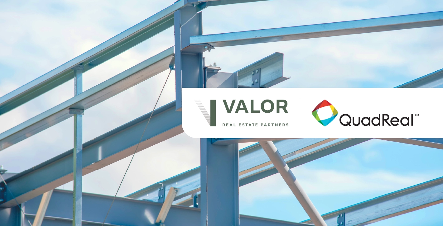 Steel framing of a building against a blue sky.