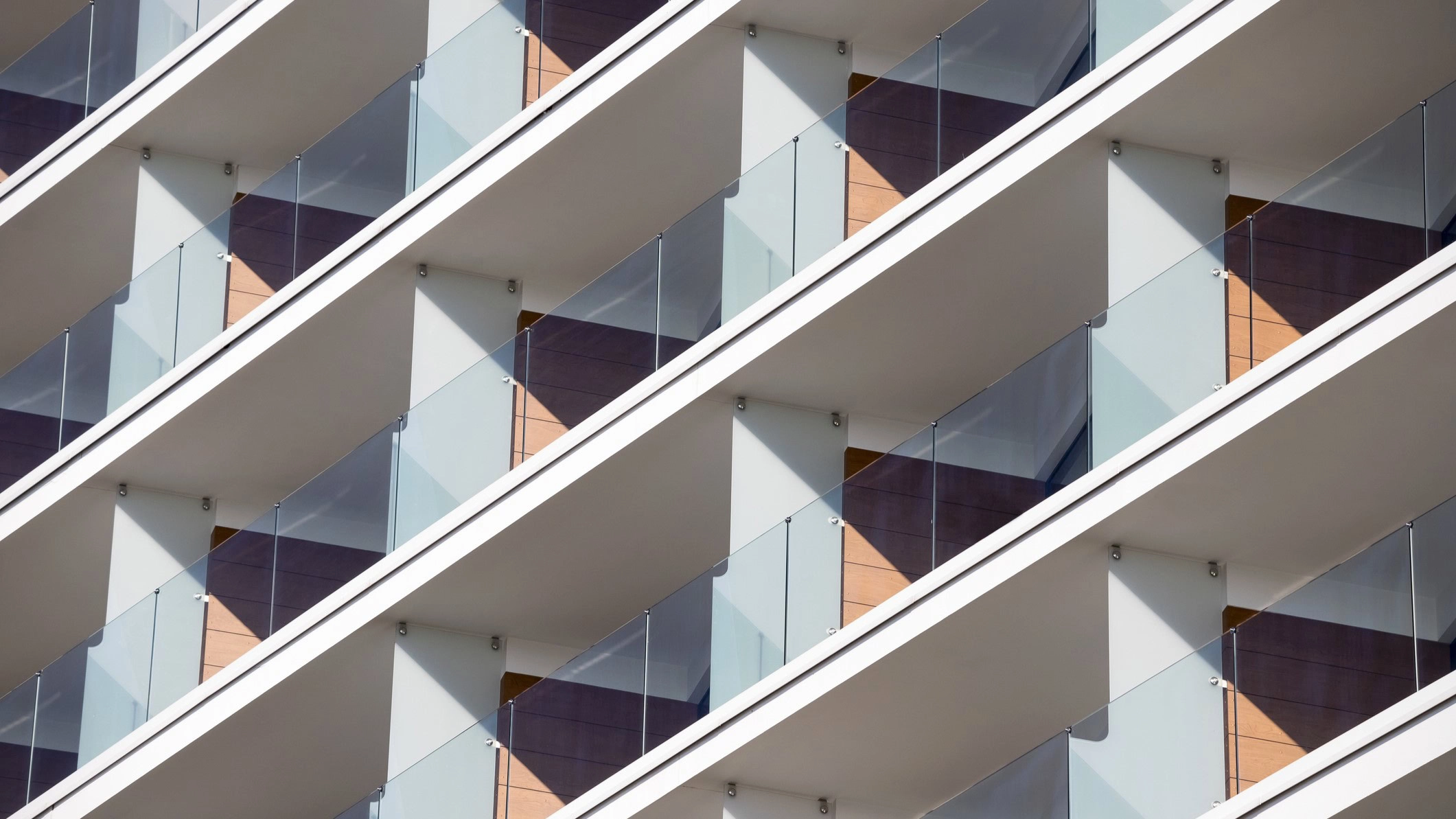 A close-up of a building's repetitive balcony pattern.