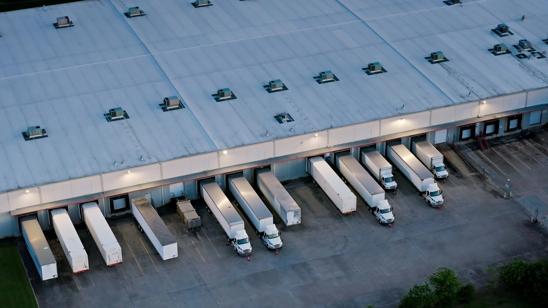 An aerial view of parked trucks at an industrial facility.
