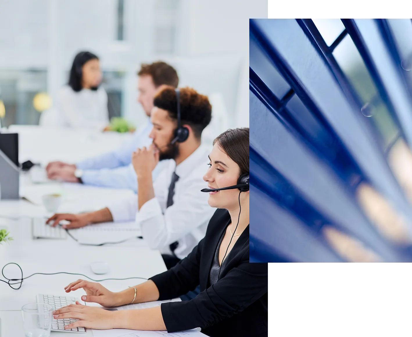 People working in a row at desks, wearing headsets, likely in a call center environment..