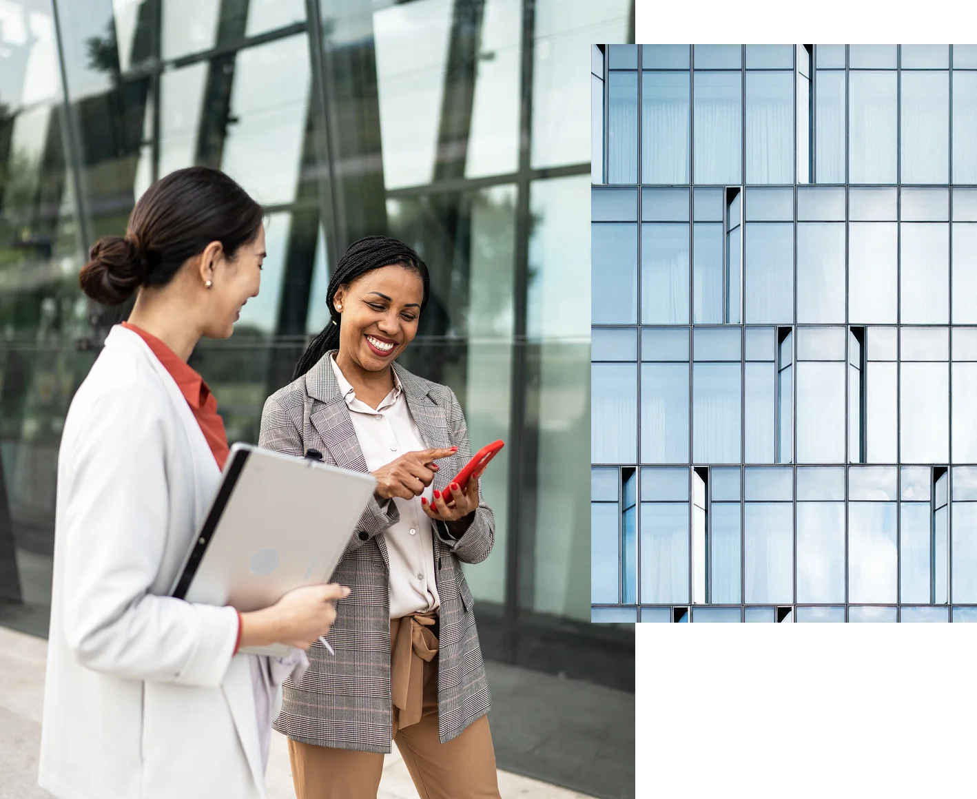 Two women are standing outside a modern glass building.