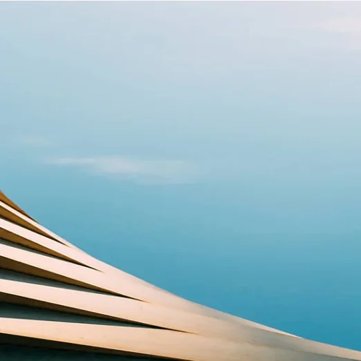 An abstract architectural detail on a blue background.