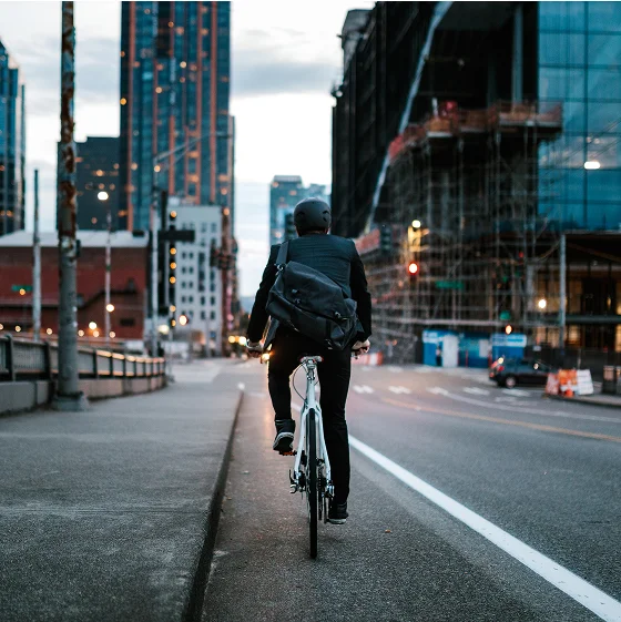 A person riding a bicycle in a city street.