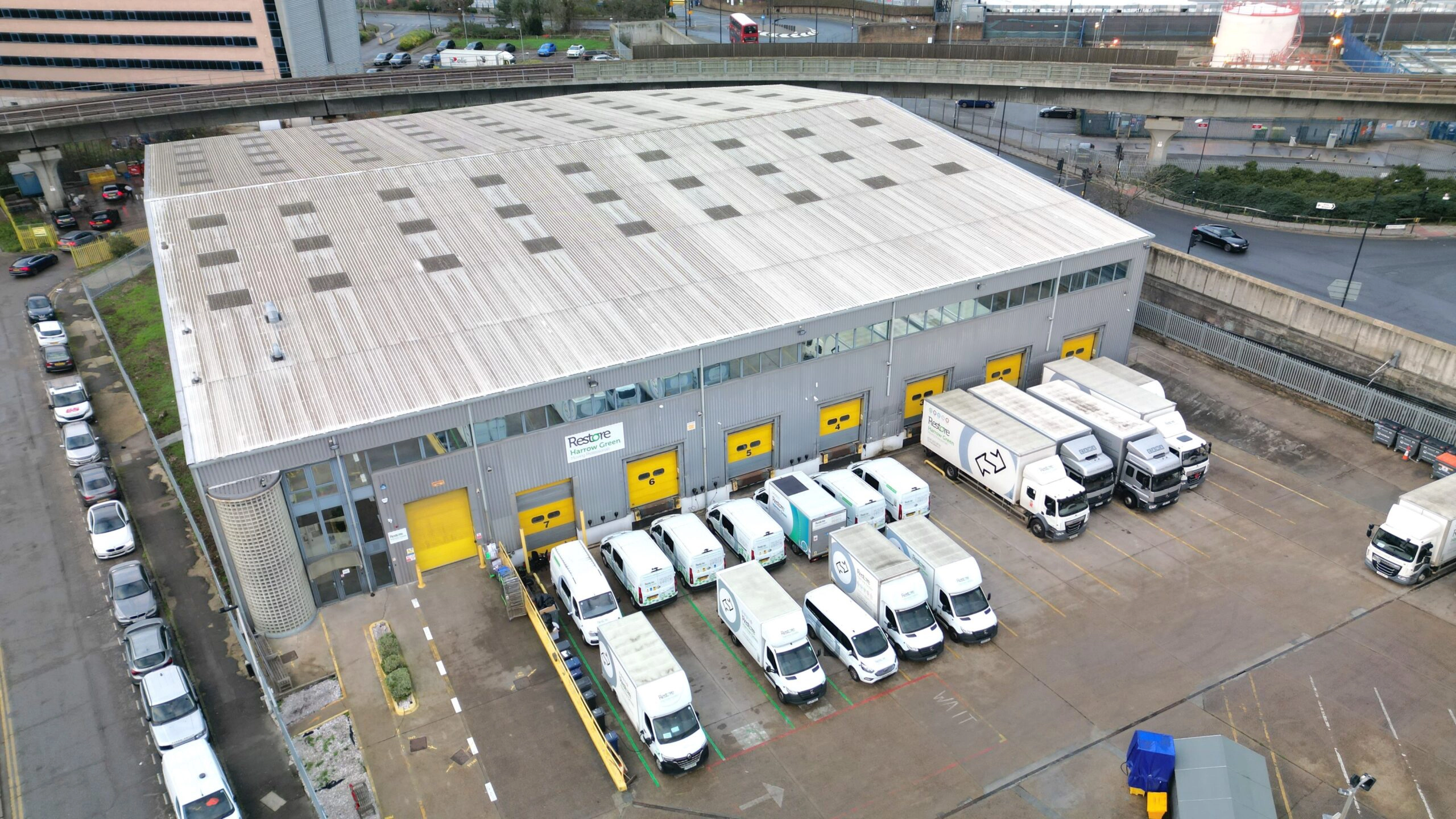 An aerial view of an industrial facility with more trucks.