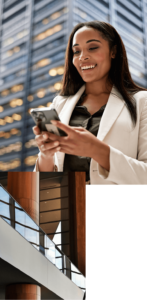 1. A person smiles while looking at their smartphone with a office tower in the background.
2. An abstract image of a modern mezzanine level of a building.