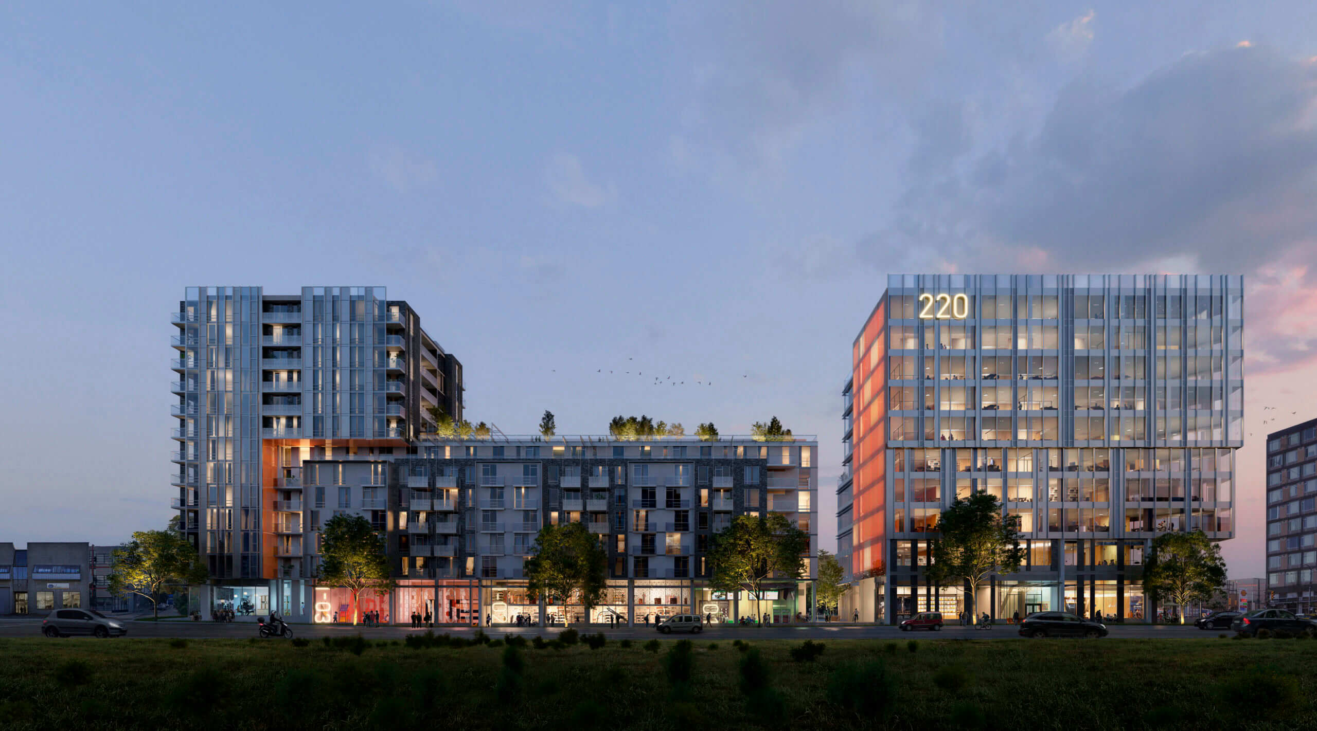 A view of a modern residential or commercial complex at dusk.