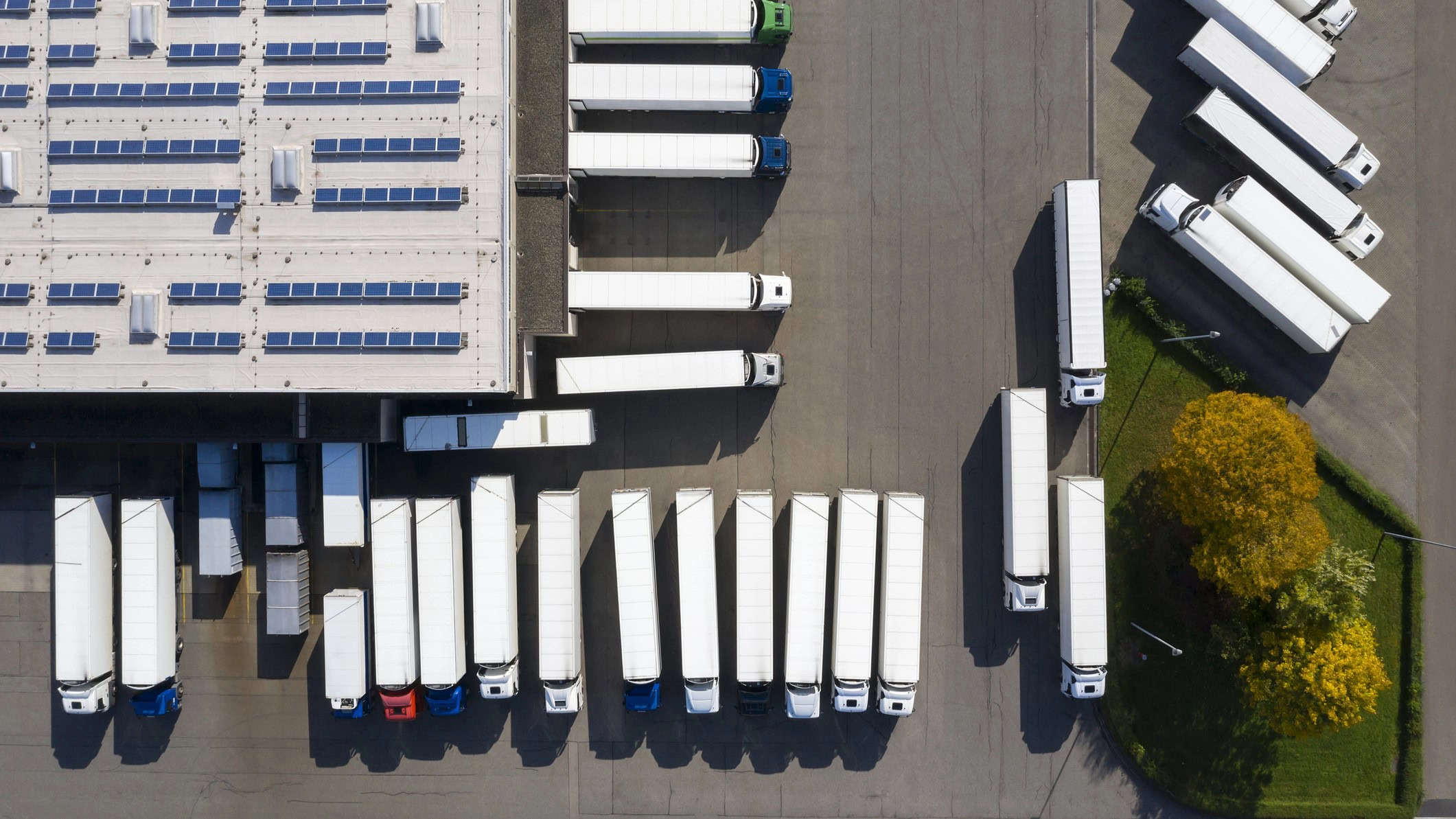 An aerial view of parked trucks in a lot.