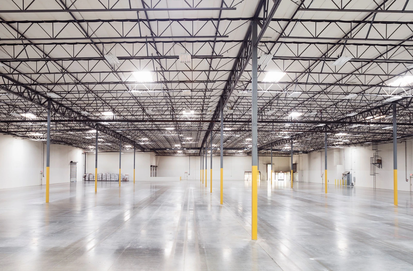 An empty industrial warehouse with high ceilings.
