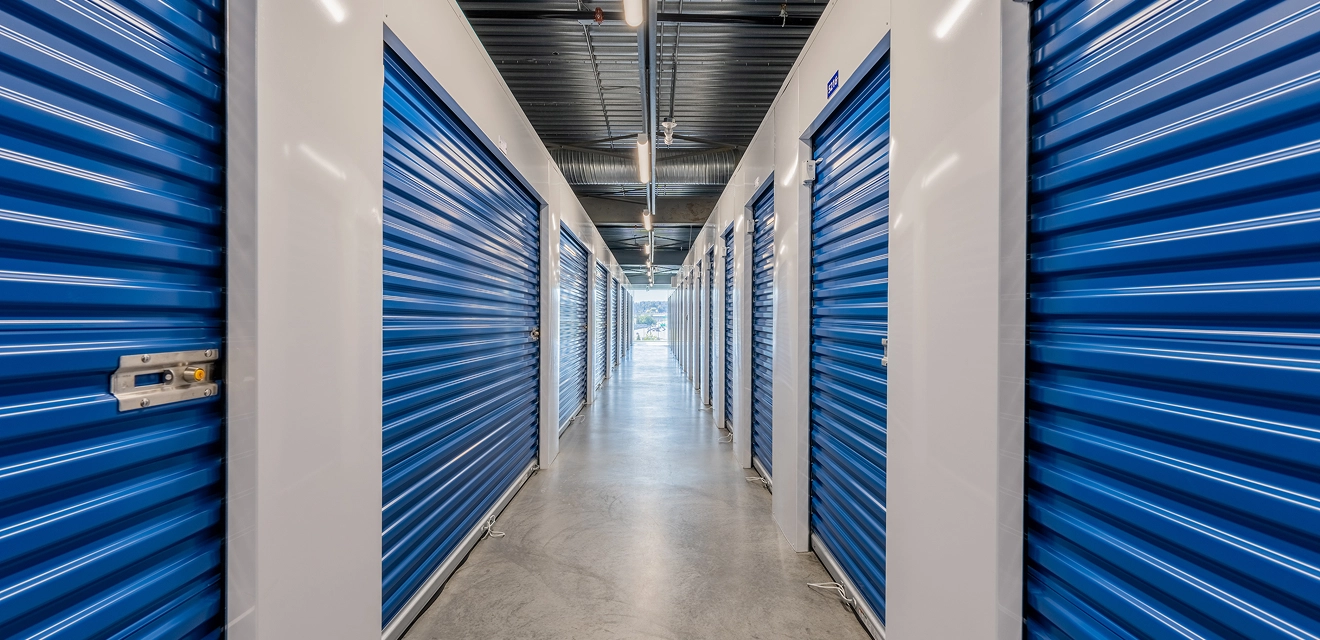 Hallway with blue storage units lining the walls.