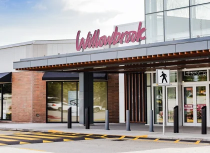 On the left, a classic storefront with a covered entrance and clear signage.